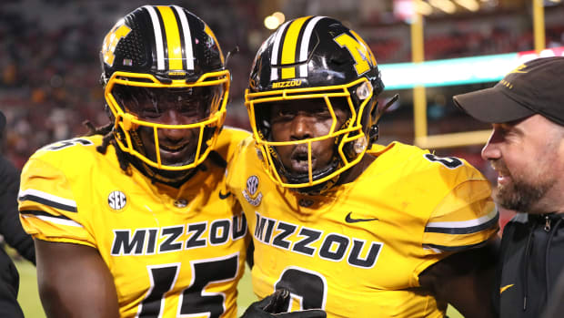 Missouri Tigers defensive lineman Johnny Walker Jr (15) and Jay Jernigan celebrate after a defensive touchdown by Jernigan in the third quarter against the Arkansas Razorbacks at Donald W. Reynolds Razorback Stadium. Missouri won 48-14.